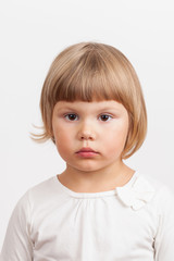 Cute serious Caucasian little girl, closeup portrait