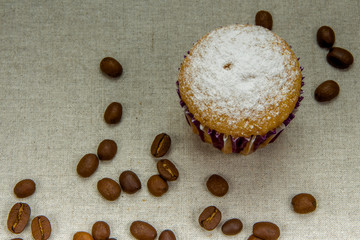 Homemade cupcakes with powdered sugar, coffee beans