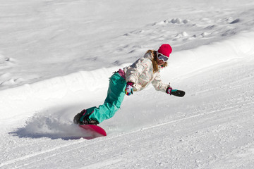 Female snowboarder rocking the slopes on a sunny morning in the Italian alps