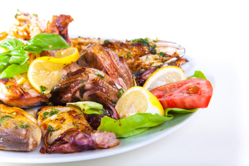 Grilled fish with vegetables on plate. Isolated on a white