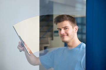 Worker Cleaning Glass With Squeegee