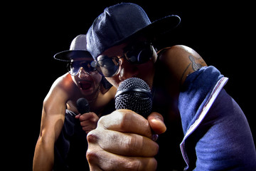Rappers having a hip hop music concert with microphones - obrazy, fototapety, plakaty
