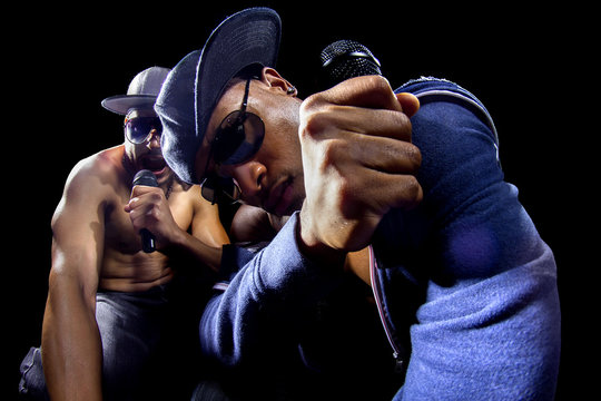 Rappers having a hip hop music concert with microphones