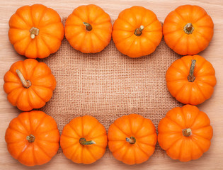 Pumpkins Frame over Burlap and Wooden Background. Harvest