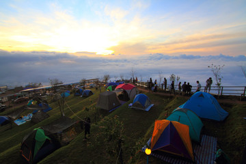 Unidentified traveler camping on the mountain and the mist on the sky