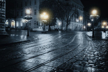 Old European city at rainy night - obrazy, fototapety, plakaty
