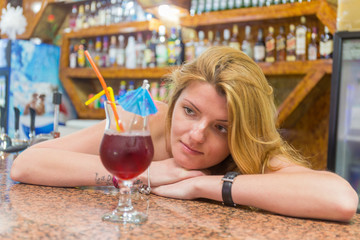 Pretty young woman with a cocktail