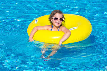  little girl swims in a pool