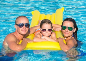 Family In Swimming Pool