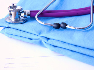 A stethoscope shaping a heart and a clipboard on a medical