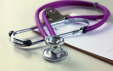 Medical stethoscope and a plate on the table