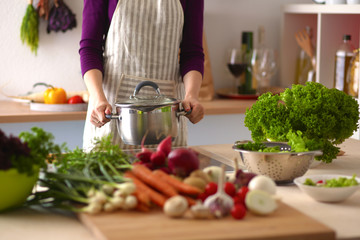 Young Woman Cooking in the kitchen. Healthy Food