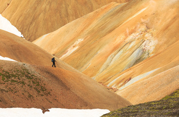 Female hiker in the colorful mountains of Landmannalaugar in Iceland.