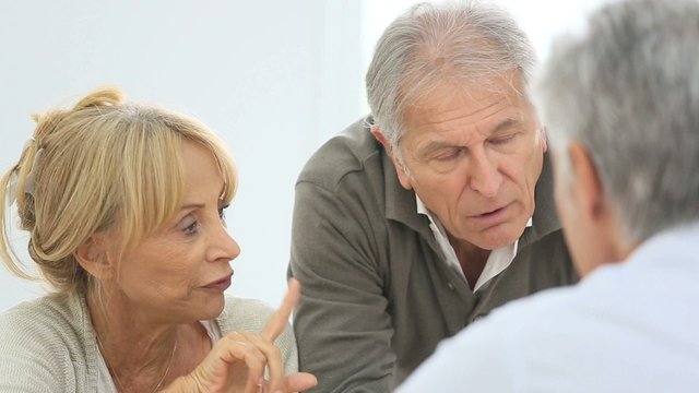 Senior people having a conversation together