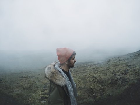 man is walking in foggy mountains 
