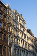 Fototapeta na wymiar Golden hour view of traditional downtown New York City architecture in the SoHo cast iron historical district