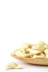 groundnuts on wooden spoon isolated on white background