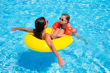 happy little girl and  mother in pool