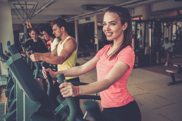 People exercising on a cardio training machines in a gym