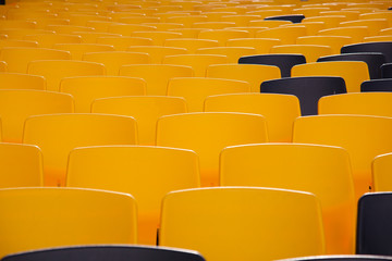 many yellow seats with few black seats
