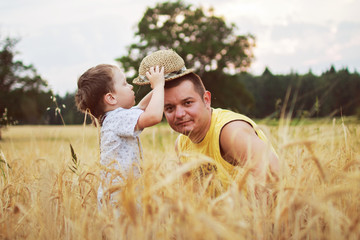 dad with son walking in a field 
