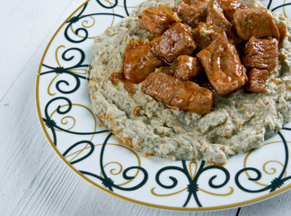 meat on a bed of baked eggplant