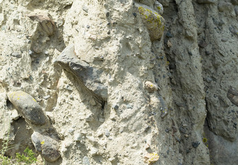 Clay surface interspersed with stones, texture.