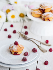 Muffins with raspberries,sprinkled with powdered sugar.selective focus
