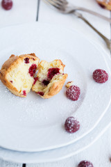 Muffins with raspberries,sprinkled with powdered sugar.selective focus