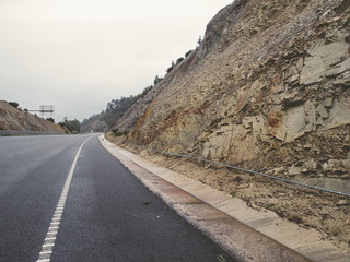 Metallic net in a hill at the edge of the road