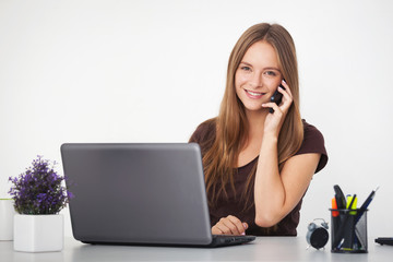 Portrait of young business woman working at her office.