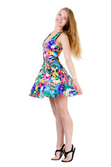 Young Beautiful blonde Girl Spinning in mix color Dress, isolated on white background, positive human emotion, facial expression