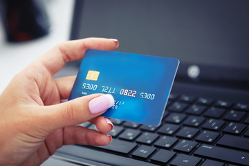 Woman hand holding credit card closeup.