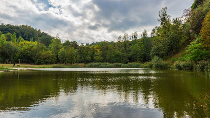Fototapeta na wymiar Amazing colorful landscape with lake and park, early fall, Lviv, Ukraine