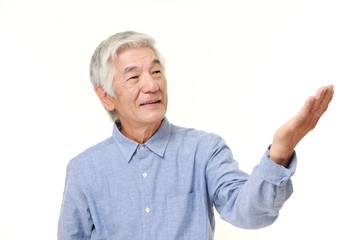 senior Japanese man presenting and showing something 