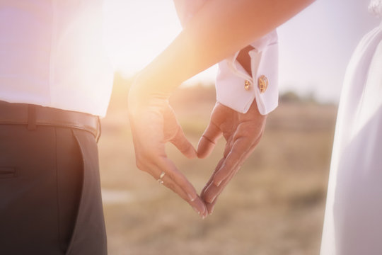 Bride and groom holding his hands