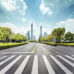empty road with zebra crossing and skyscrapers