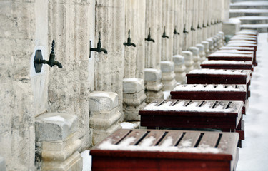 Taps for prayer ablution in Suleymaniye Mosque under snow, İstanbul, Turkey.