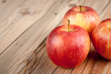 Ripe red apples on wooden table