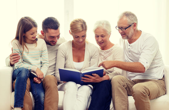 happy family with book or photo album at home