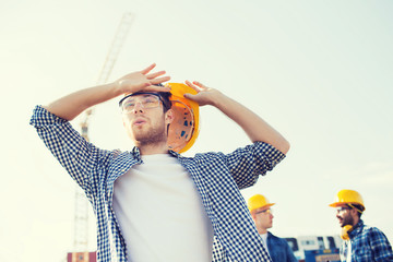 group of builders in hardhats outdoors