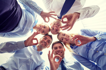smiling group of businesspeople standing in circle
