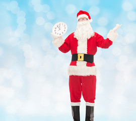 man in costume of santa claus with clock
