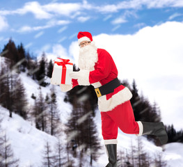 man in costume of santa claus with gift box