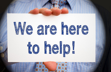 We are here to help - Businessman with sign and text