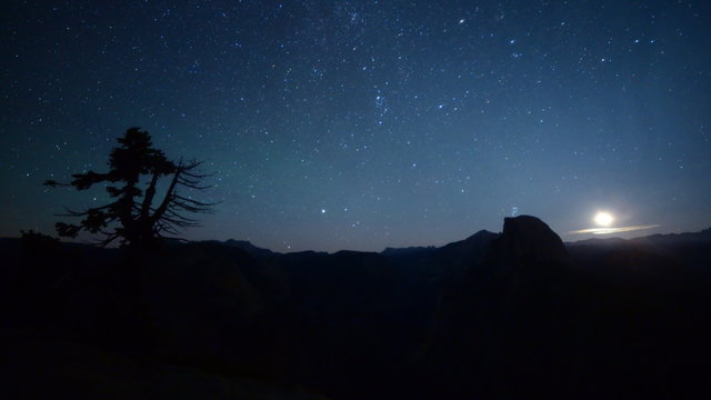 3 axis motion controlled astrophotography time lapse footage with dolly up / tilt down/ pan right  / zoom out motion of milky way and moon rise over Half Dome at Glacier Point in Yosemite National Park, California