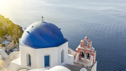 Sun on a blue dome in Oia