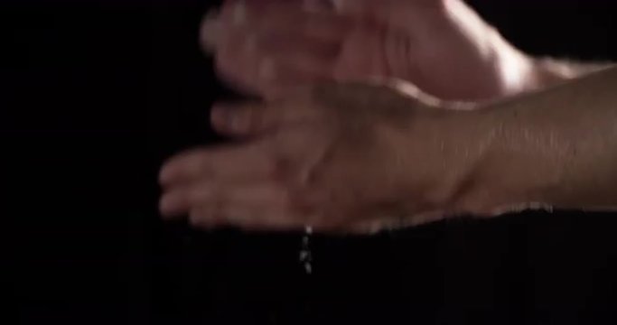 man clspping hands with flour or talc in 60fps slow motion