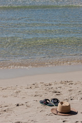 Fototapeta na wymiar Beach on tropical island. Clear blue water, sand, clouds. 