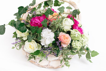 gift basket of flowers whith roses peonies hydrangea isolated